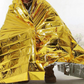 Human Body Hypothermia Lifesaving Emergency Blanket In Outdoor Field - Locust
